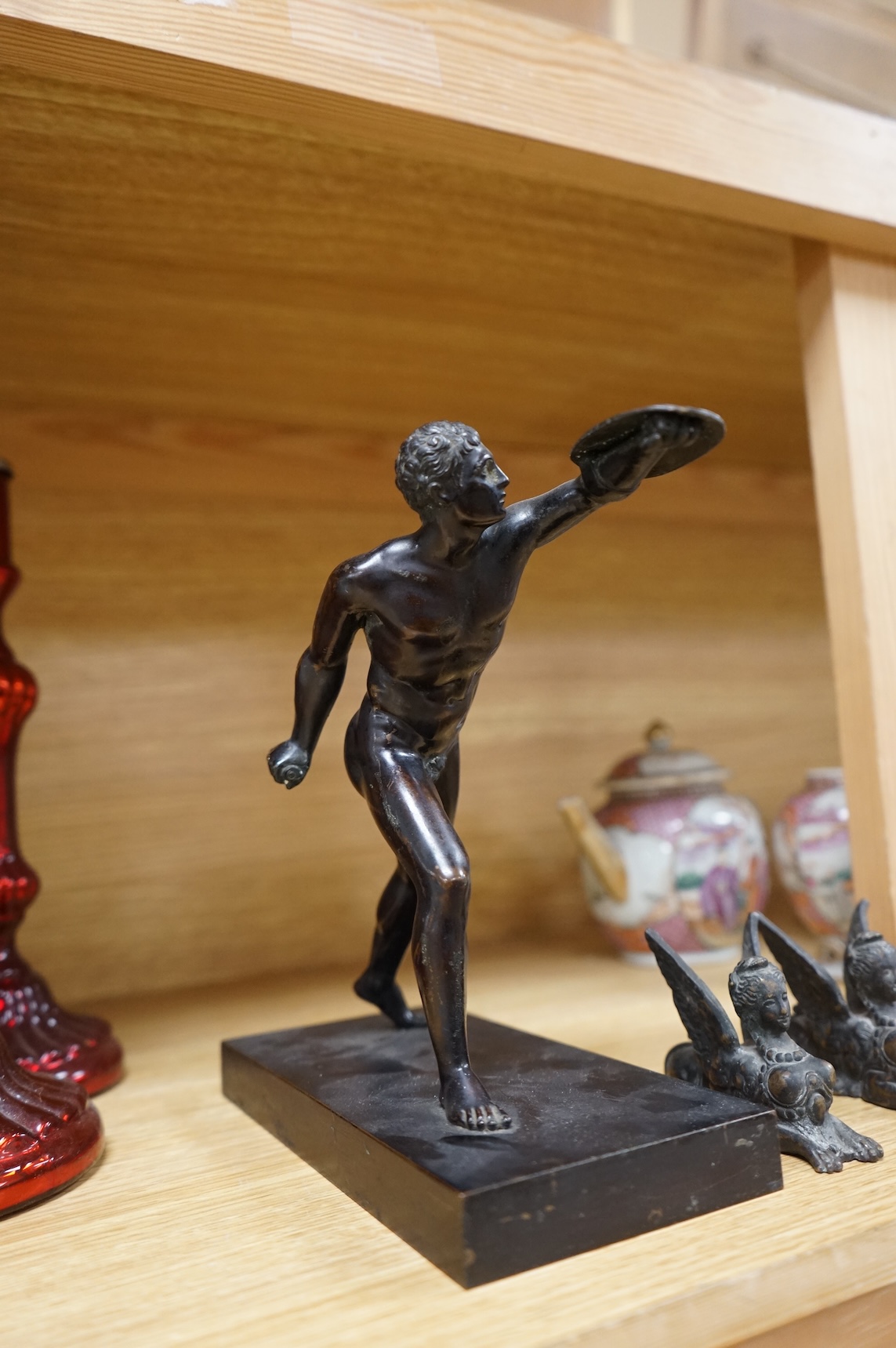 After the antique, a bronze figure of a warrior and two small studies of sphinx, largest 21cm high